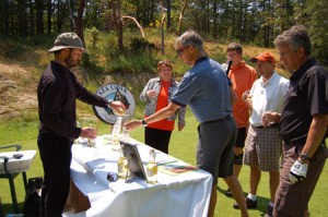 Pouring cider at the spectacular 17th hole at Olympic View Golf Course